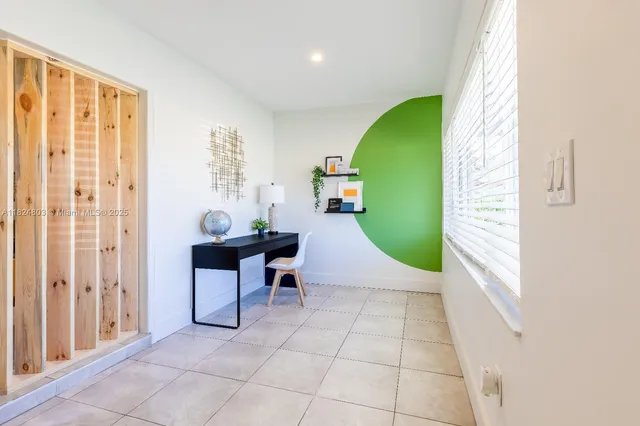 a view of a livingroom with furniture and a window