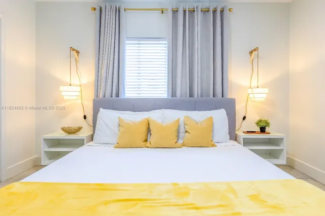 a bedroom with a bed and window