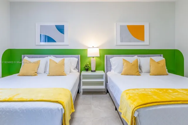 a bedroom with a bed and painting on the wall