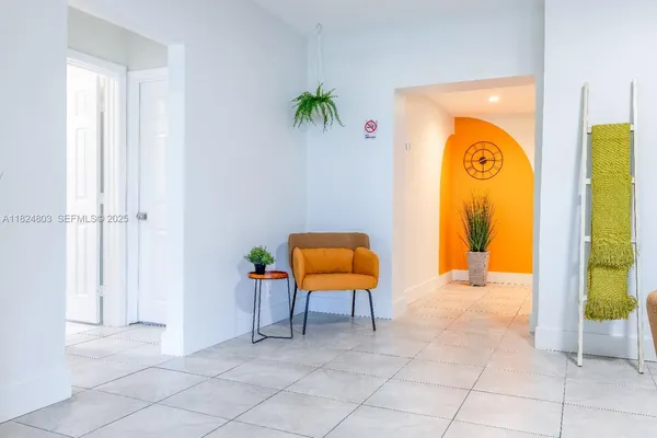 a view of an entryway with a table and chair