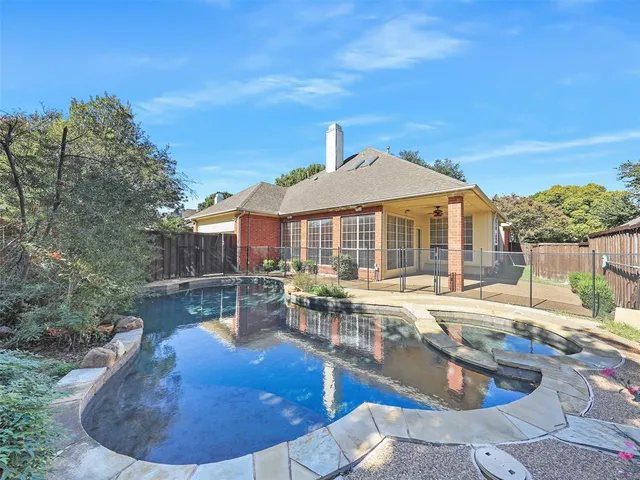 a view of a house with swimming pool and sitting area