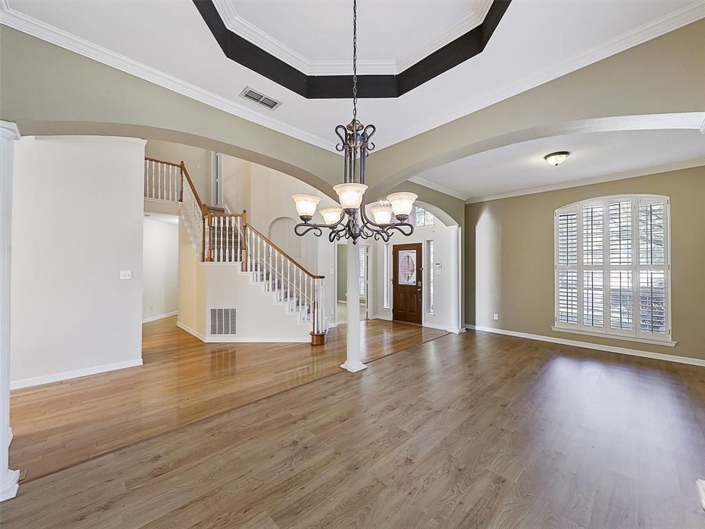 4620 Portrait Lane Plano, TX 75024 - Photo 8 of 25 a view of a room with wooden floor chandelier and a window