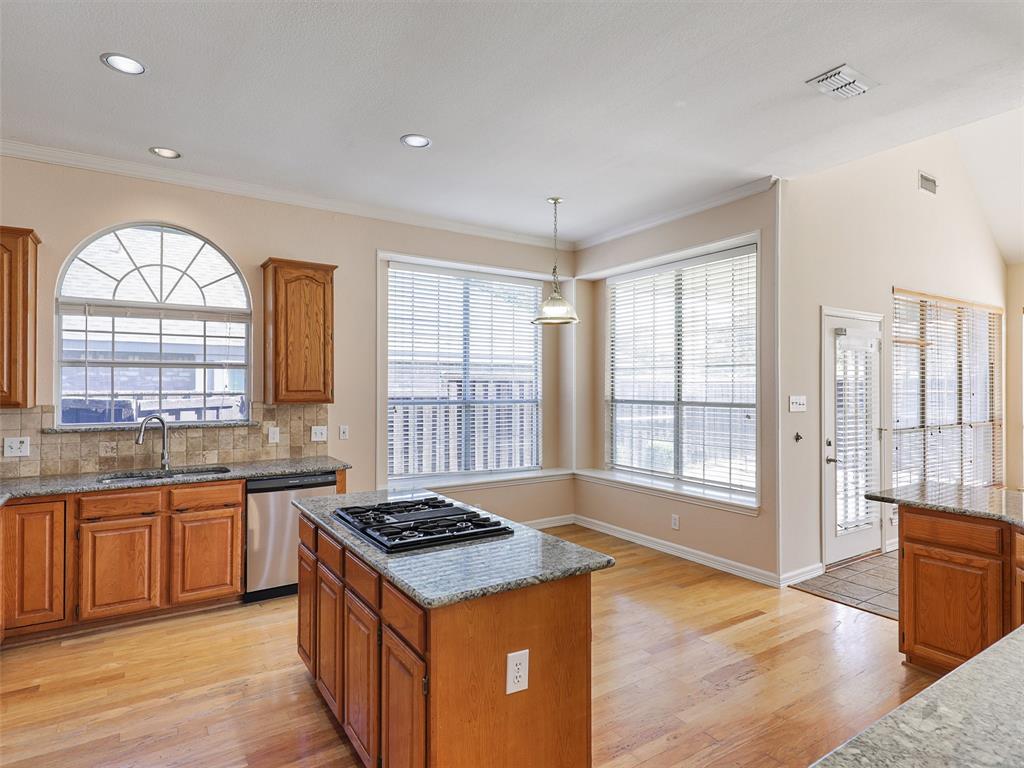4620 Portrait Lane Plano, TX 75024 - Photo 10 of 25 a large kitchen with stainless steel appliances granite countertop a stove and a sink