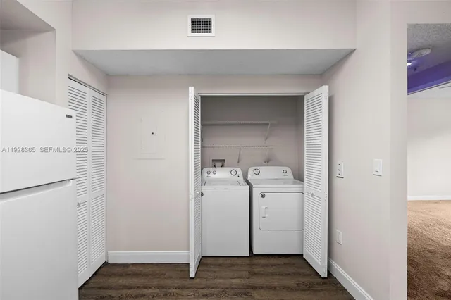 a view of a big room with windows and ceiling fan