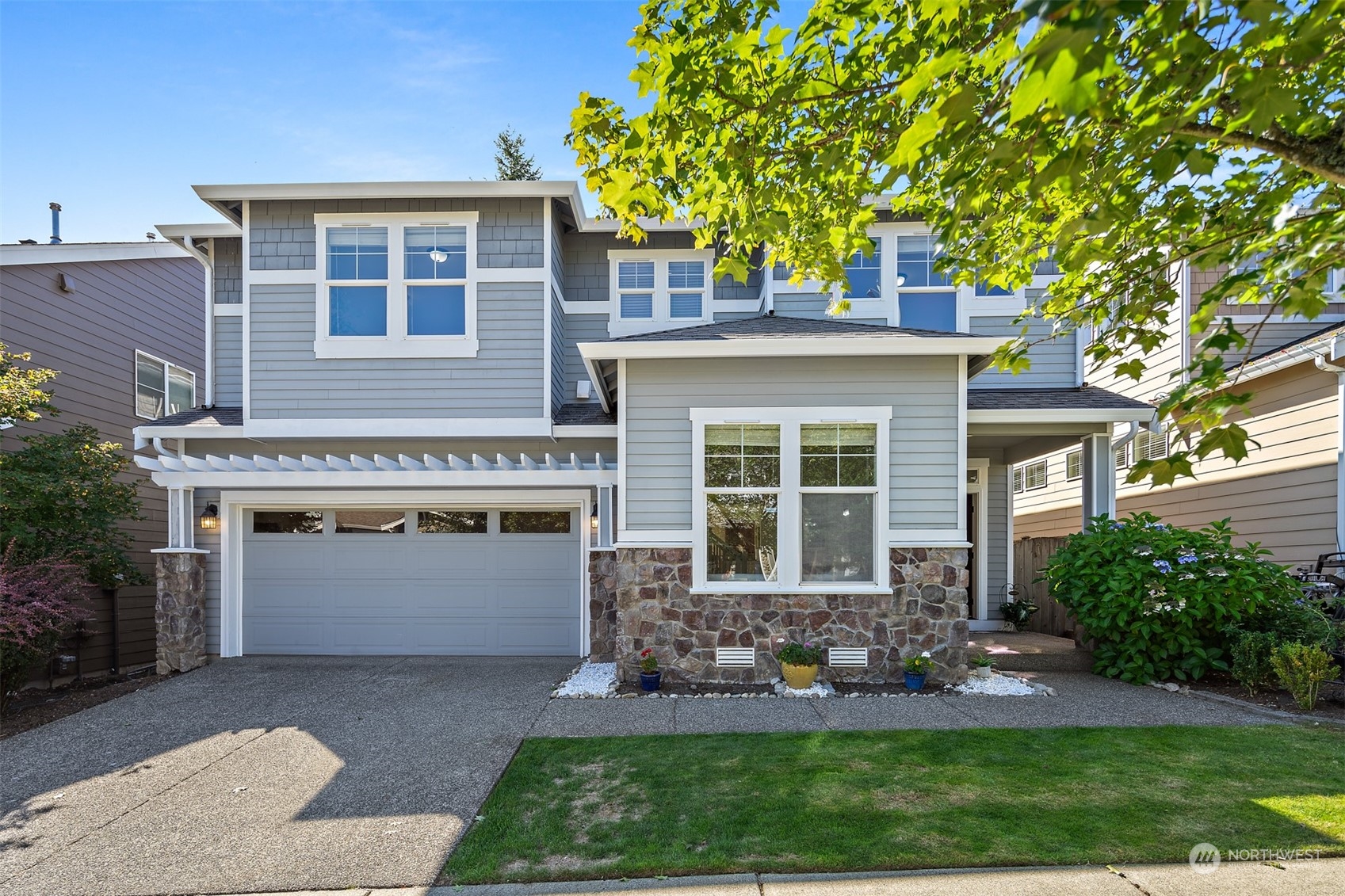 a front view of a house with a yard and garage