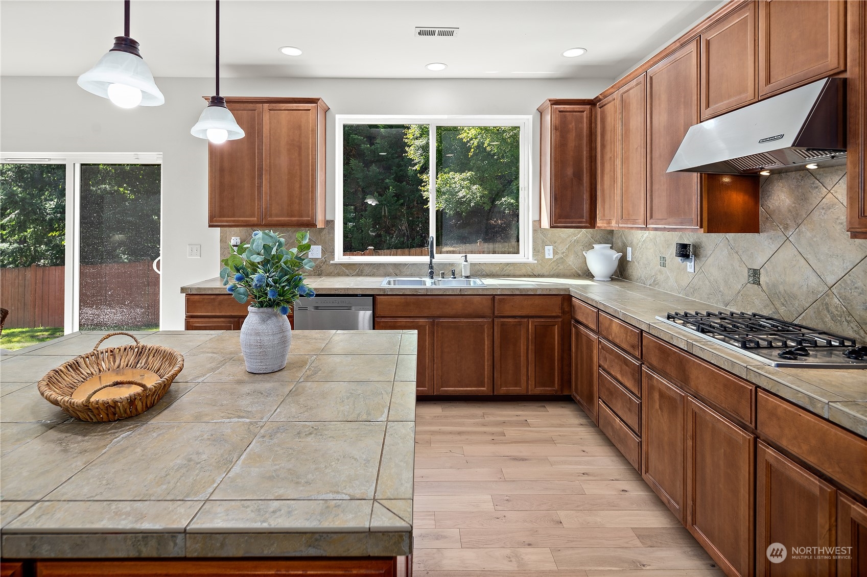 22920 36th Avenue Southeast Bothell, WA 98021 - Photo 11 of 30 a kitchen with stainless steel appliances granite countertop a sink counter space cabinets and a large window