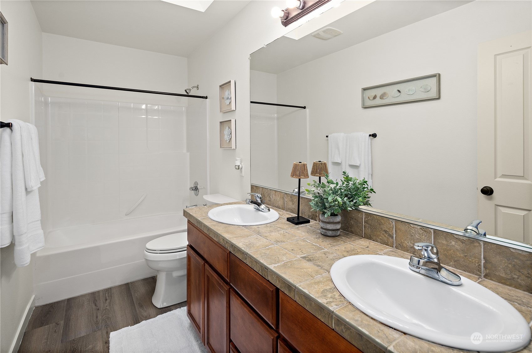 22920 36th Avenue Southeast Bothell, WA 98021 - Photo 20 of 30 a bathroom with a granite countertop sink a toilet a mirror and shower