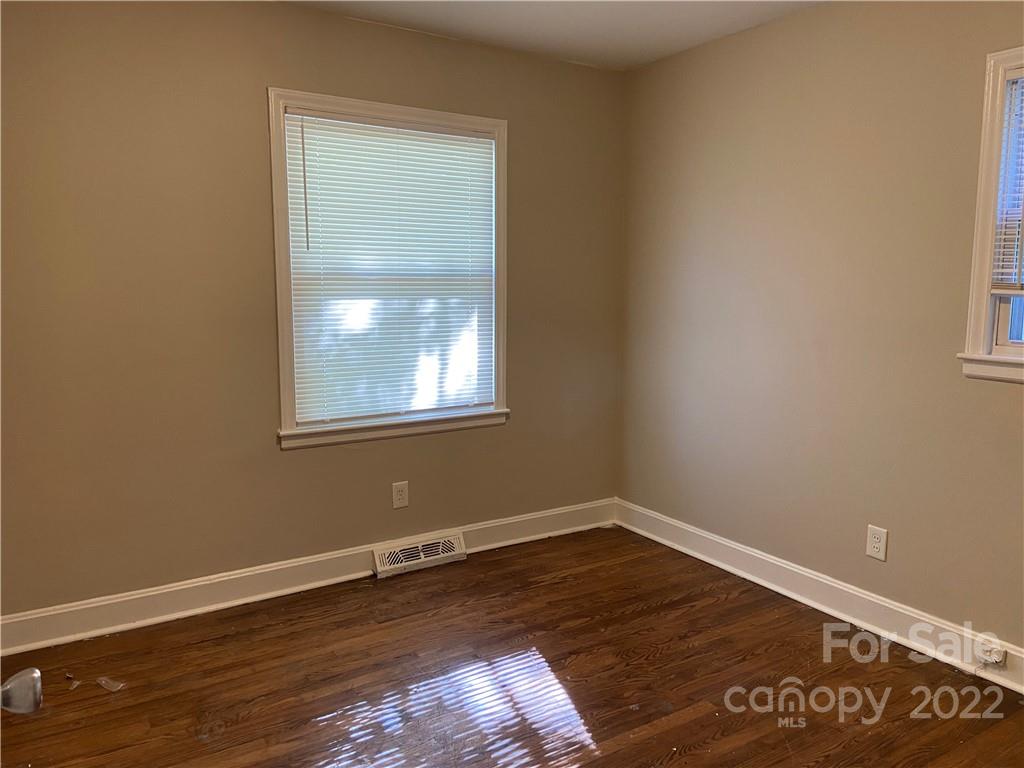 4518 Ridgeley Drive Charlotte, NC 28208 - Photo 17 of 18 a view of a room with wooden floor and windows