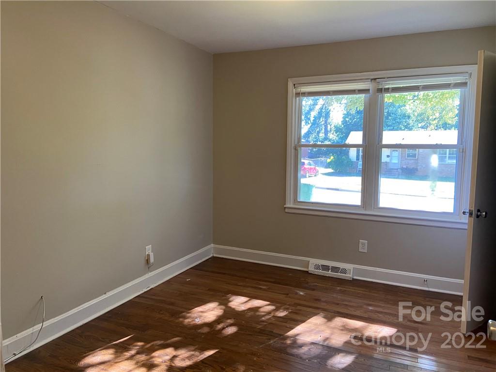 4518 Ridgeley Drive Charlotte, NC 28208 - Photo 18 of 18 a view of a room with wooden floor and a window