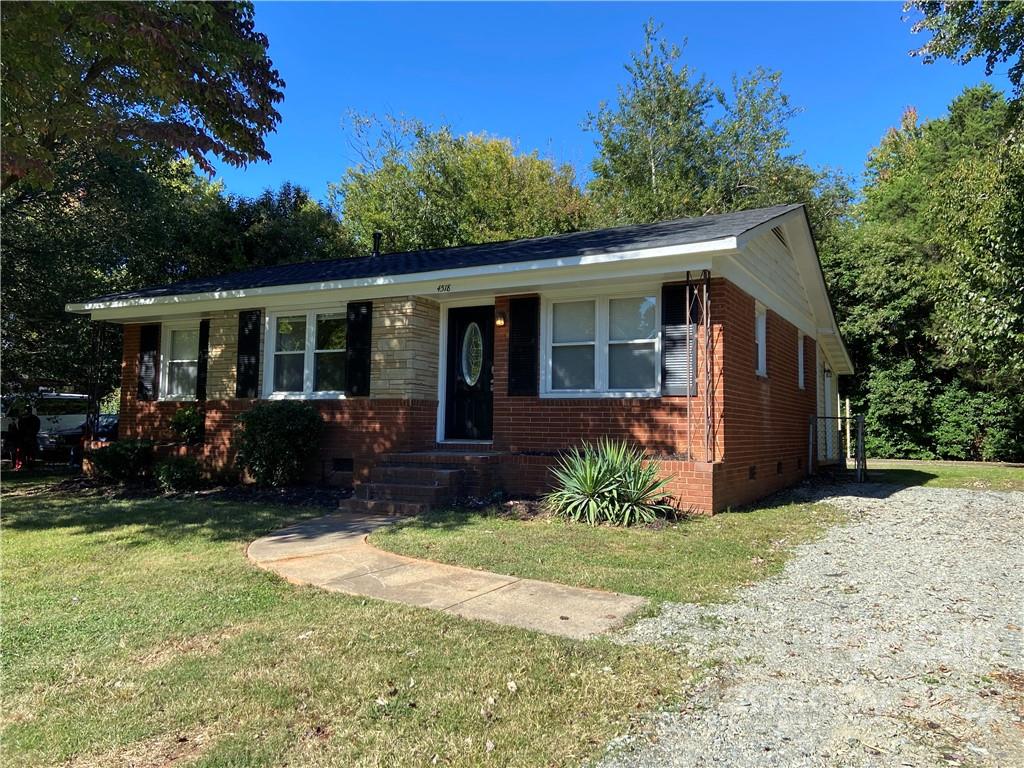 4518 Ridgeley Drive Charlotte, NC 28208 - Photo 2 of 18 a front view of a house with a yard and potted plants
