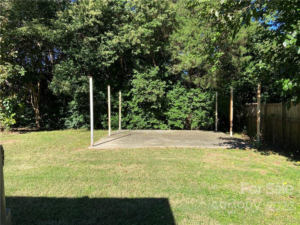 4518 Ridgeley Drive Charlotte, NC 28208 - Photo 4 of 18 a view of a swimming pool and trees in the background