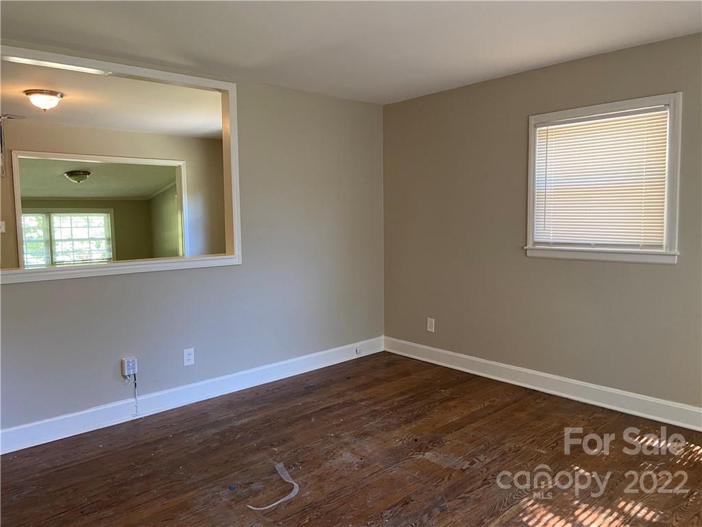 4518 Ridgeley Drive Charlotte, NC 28208 - Photo 6 of 18 wooden floor in an empty room with a window