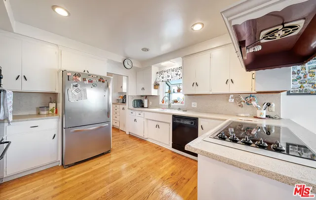 a kitchen with a refrigerator sink and stove