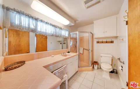 a spacious bathroom with a tub sink and a shower