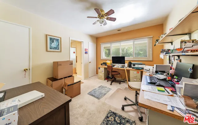 a work room with furniture and a large window