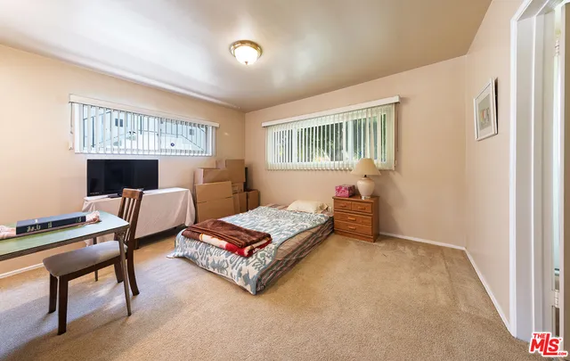 a bedroom with furniture and a window