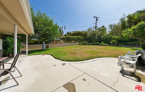 a view of a swimming pool with a yard