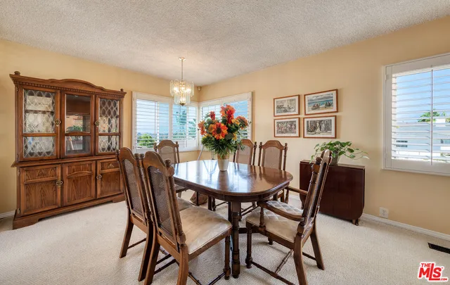a view of a dining room with furniture and window