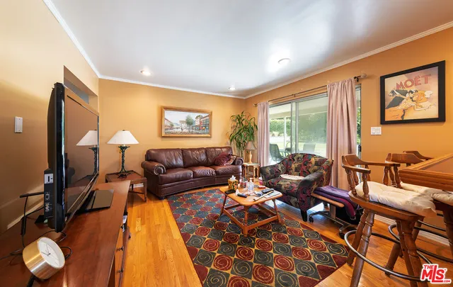 a living room with furniture and a floor to ceiling window