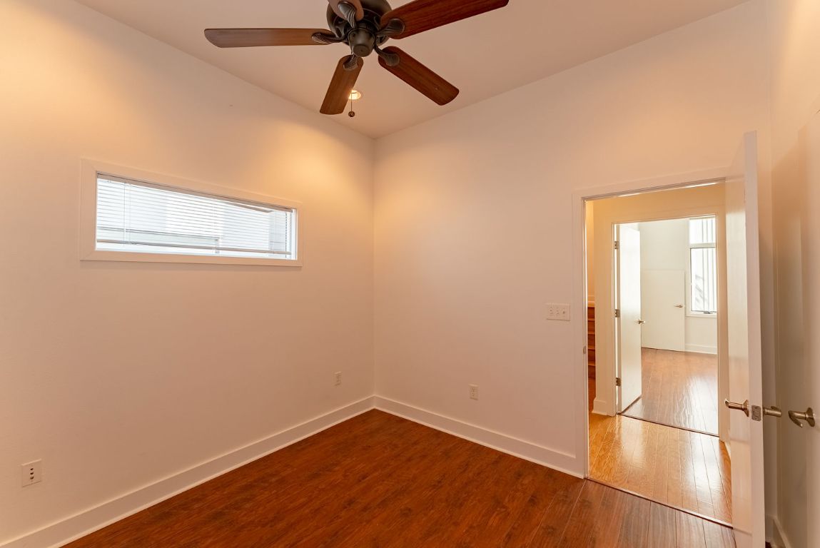 1702 South Lamar Boulevard, Unit 27 Austin, TX 78704 - Photo 12 of 20 Unfurnished room featuring dark wood-style flooring and a ceiling fan