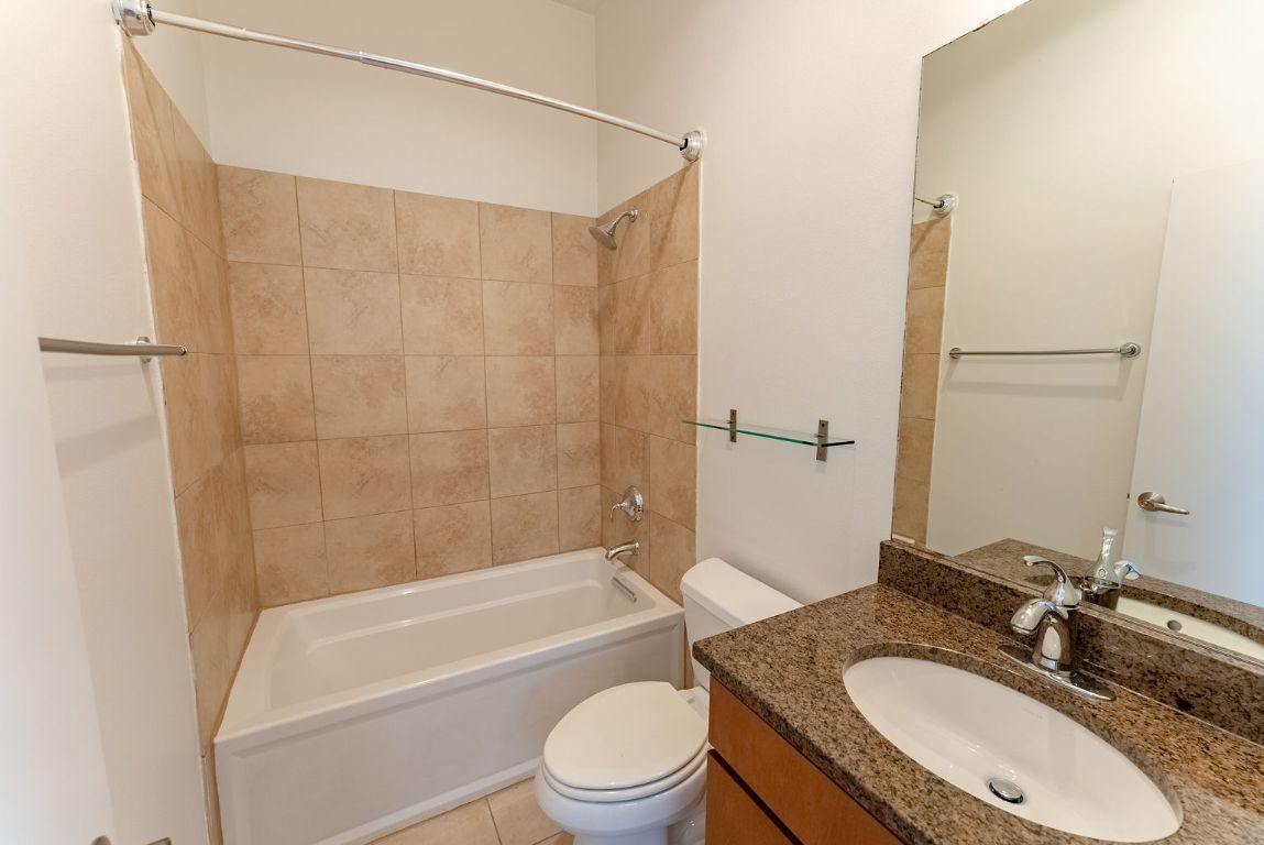 1702 South Lamar Boulevard, Unit 27 Austin, TX 78704 - Photo 13 of 20 Full bathroom with vanity, shower / bathtub combination, and light tile patterned flooring