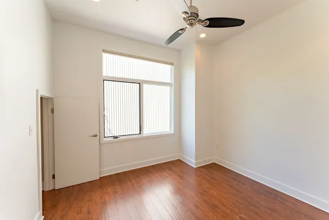 a view of a room with wooden floor