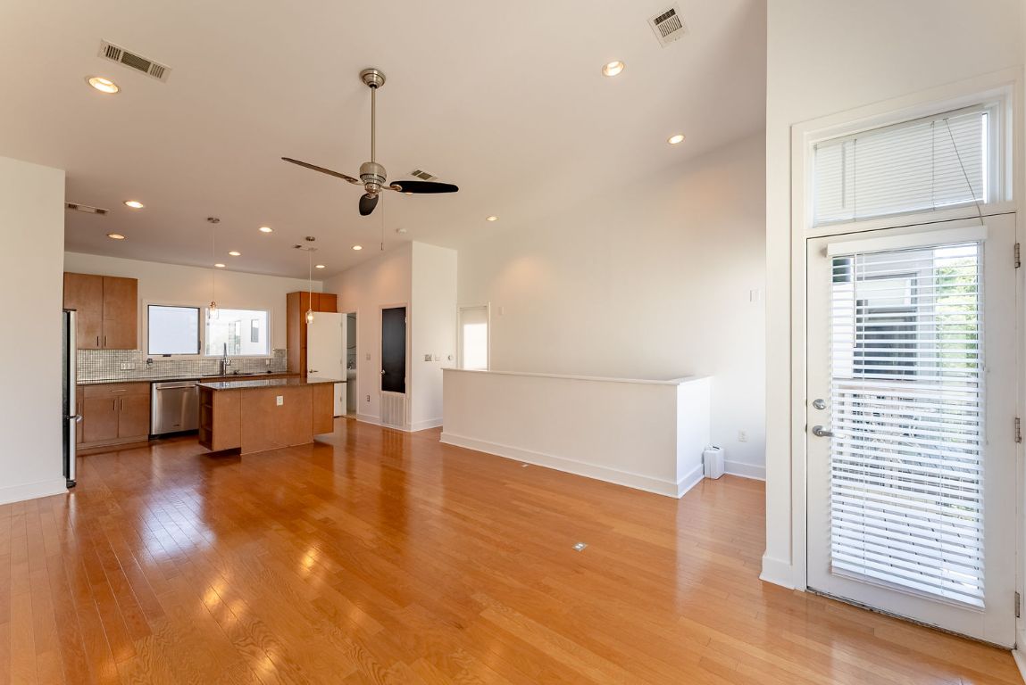 1702 South Lamar Boulevard, Unit 27 Austin, TX 78704 - Photo 2 of 20 Unfurnished living room featuring light wood-type flooring, ceiling fan, and recessed lighting
