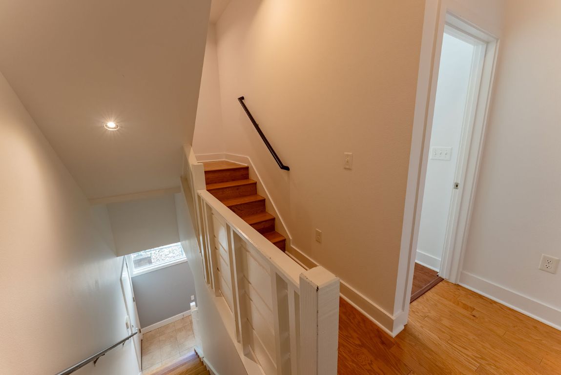 1702 South Lamar Boulevard, Unit 27 Austin, TX 78704 - Photo 9 of 20 Staircase featuring baseboards and wood finished floors