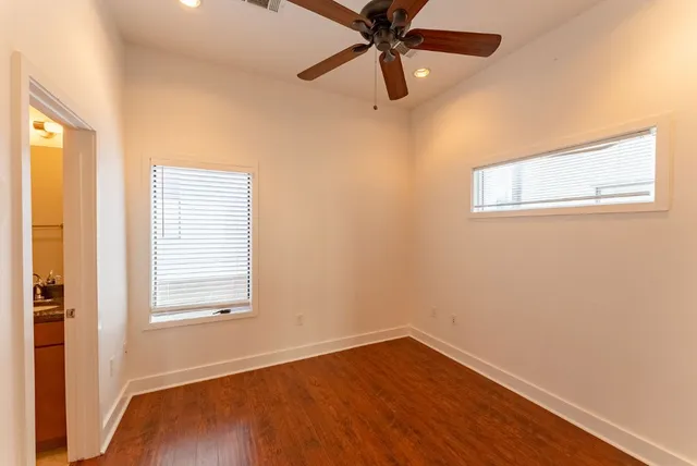 a view of empty room with wooden floor