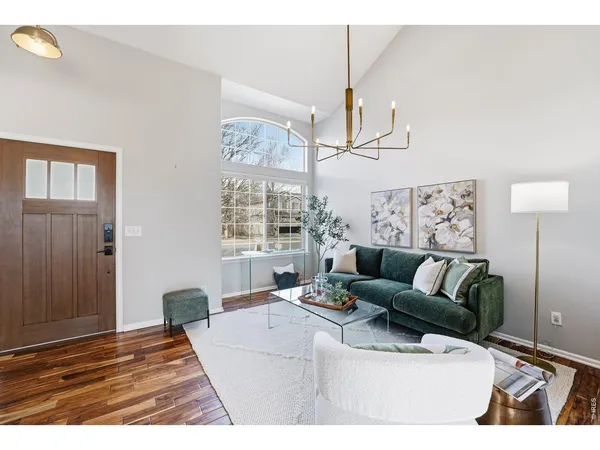 a living room with furniture and a chandelier