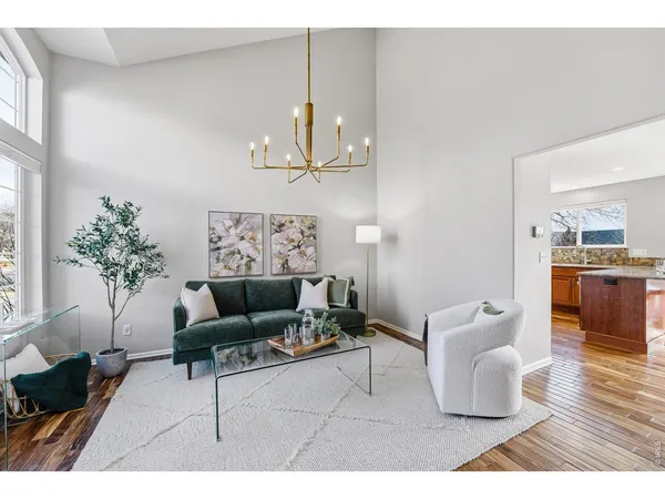a living room with furniture and a chandelier
