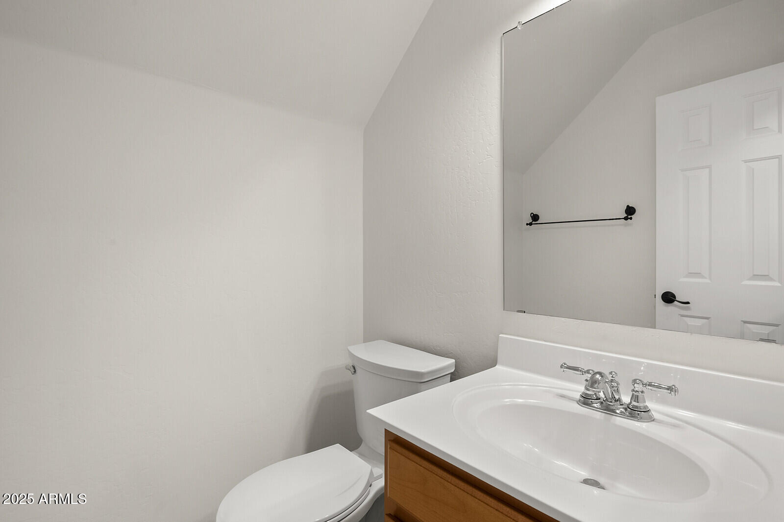 3297 East Warbler Road Gilbert, AZ 85297 - Photo 14 of 32 a bathroom with a sink a toilet and a mirror
