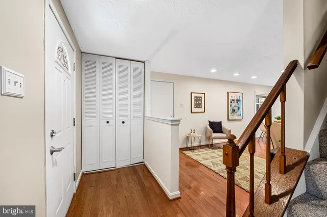 a view of an entryway with wooden floor and stairs