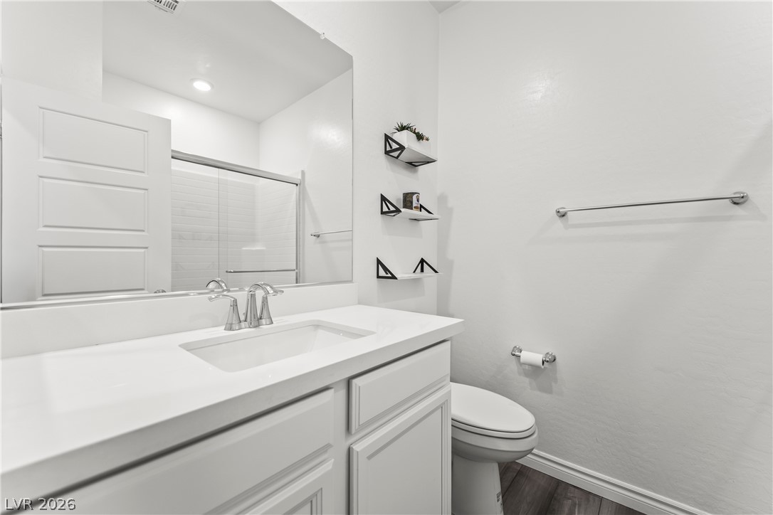 7204 North Decatur Boulevard, Unit 5 North Las Vegas, NV 89084 - Photo 25 of 34 An undermount sink and stone counter define this contemporary bathroom vanity space.