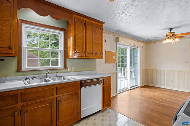 a kitchen with a sink cabinets and wooden floor