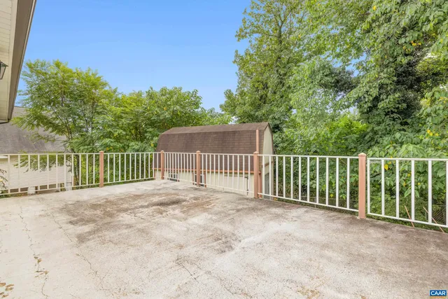 a view of a fence and trees in the background