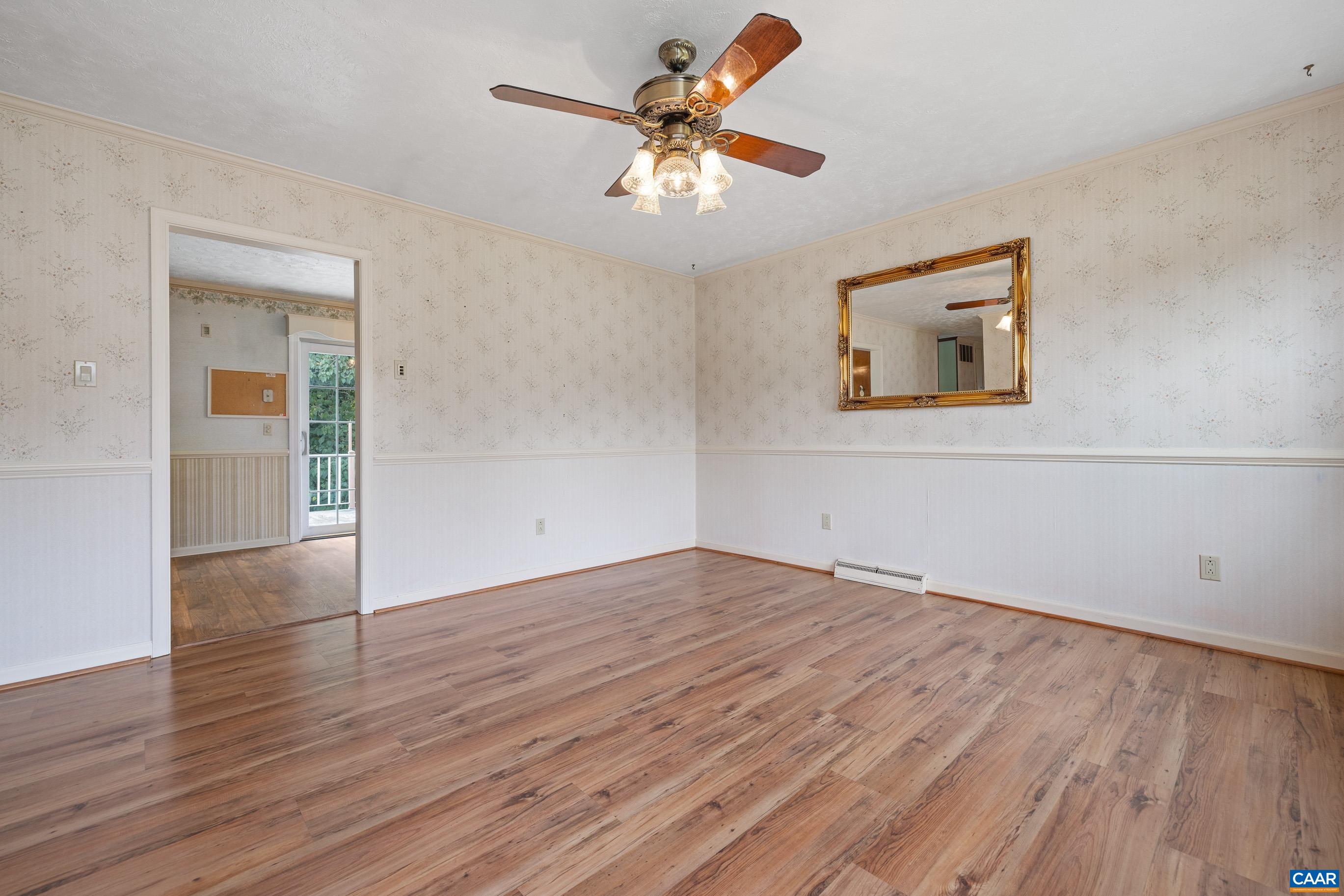 408 Carlton Road Charlottesville, VA 22902 - Photo 6 of 28 a view of an empty room with window and wooden floor