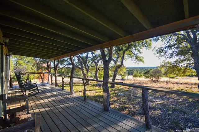 a living room with furniture a rug and a chandelier