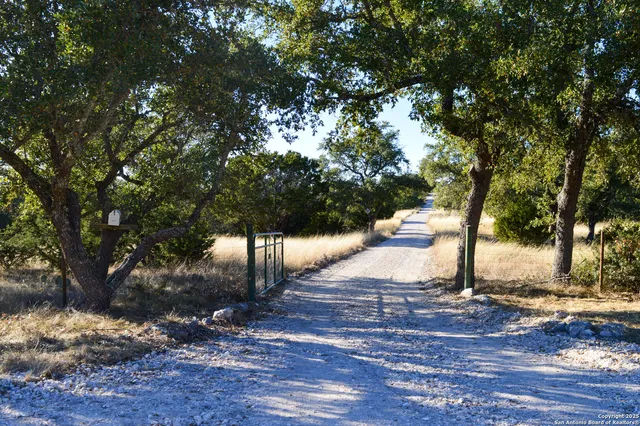 a backyard of a house with yard table and chairs