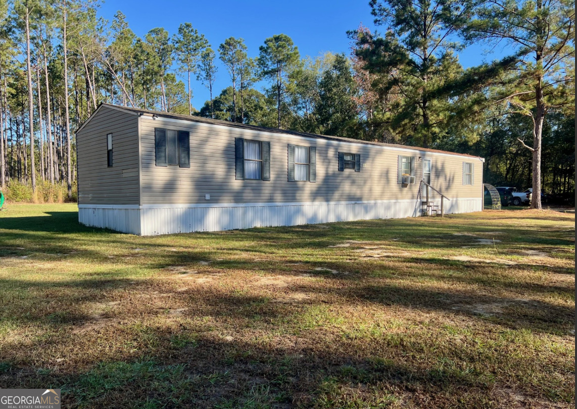 6055 Sun Hill Grange Road Davisboro, GA 31018 - Photo 1 of 1 a view of a house with a yard