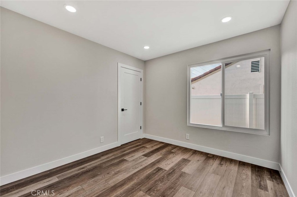 1798 Moorpark Drive Brea, CA 92821 - Photo 51 of 71 an empty room with wooden floor and windows