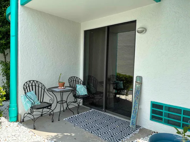 a view of a balcony with chair and front door