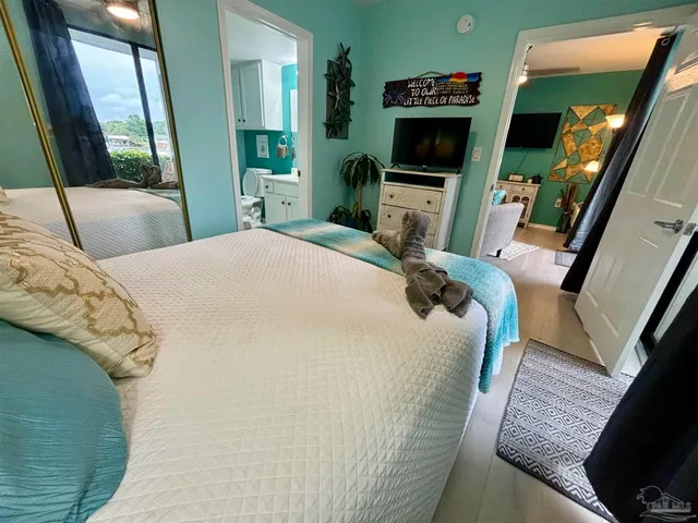 a bedroom with a bed window and a television