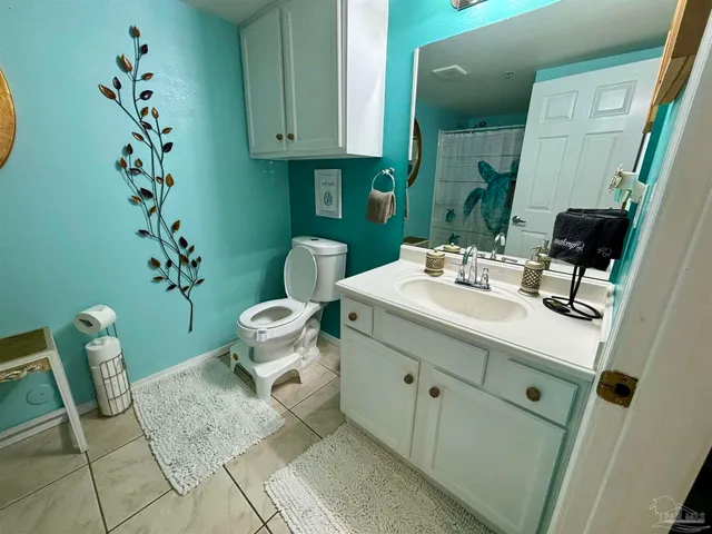 a bathroom with a sink toilet and mirror