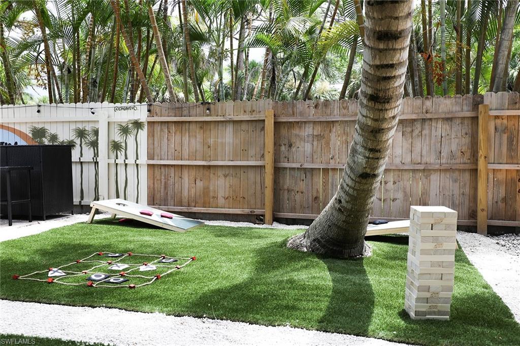 2780 Weeks Avenue Naples, FL 34112 - Photo 19 of 34 a garden with trees in front of it