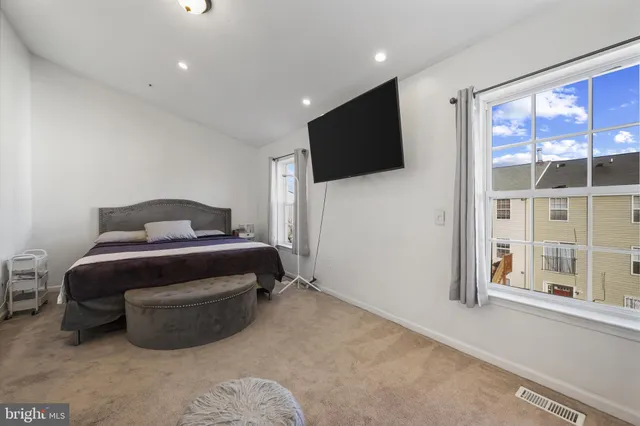a bedroom with a bed and flat screen tv