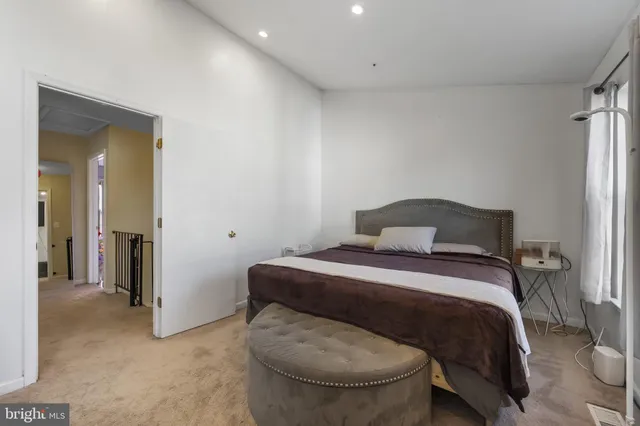 a bedroom with a bed and a chair