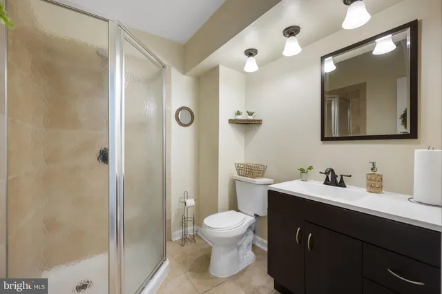 a bathroom with a toilet sink a mirror and shower
