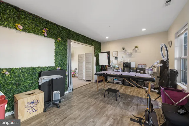 a view of a workspace with furniture and a table