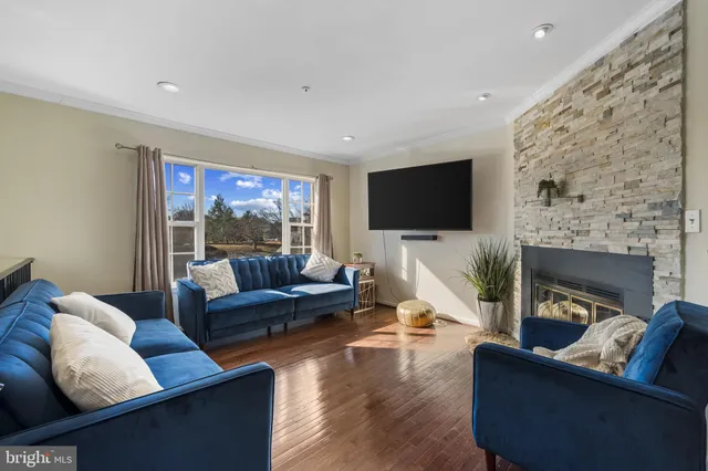a living room with fireplace furniture and a flat screen tv